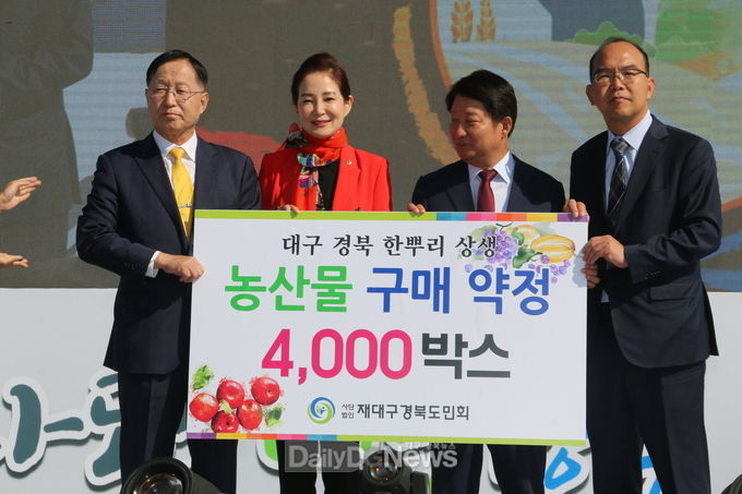 (사)재대구경북도민회회장이 대구․경북의 두 단체장에게 ‘대구․경북 농산물 구매 약정서’를 전달하고 있다. (사진=이준호 기자)