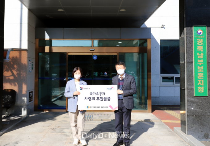 경북남부보훈지청 장정례 복지과장(좌)과 건협 경북지부 이강원 사업관리부장(우)이 후원품 전달식을 하고 있다.