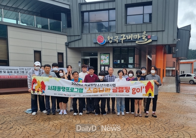 사제동행프로그램에 참여한 학습지원단 교사와 학교밖청소년들이 캠핑장 입구에서 기념사진을 촬영하고 있다