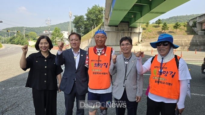 임동주 경주시 문화관광국장이 만불사 입구에서 이범식 박사의 도보 종주를 응원하며 기념쵤영을 하고 있다